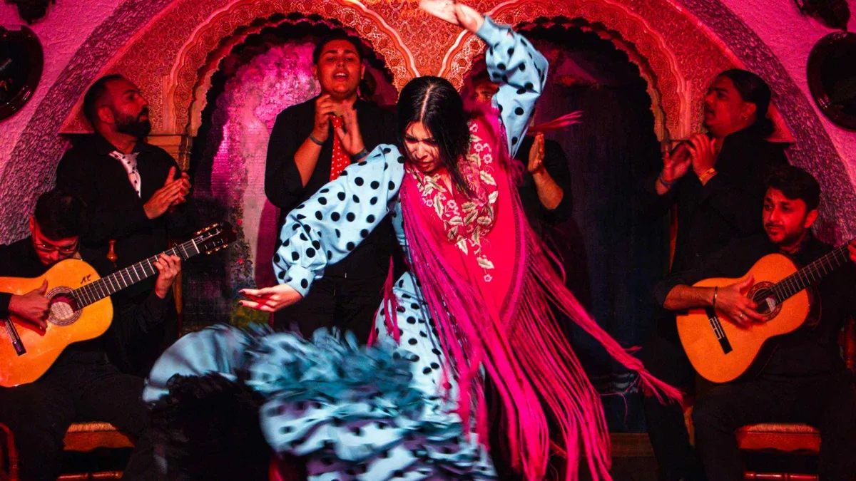 Flamenco singer and guitarist on the low stage of Tablao Cordobés during a flamenco show in Barcelona, Spain